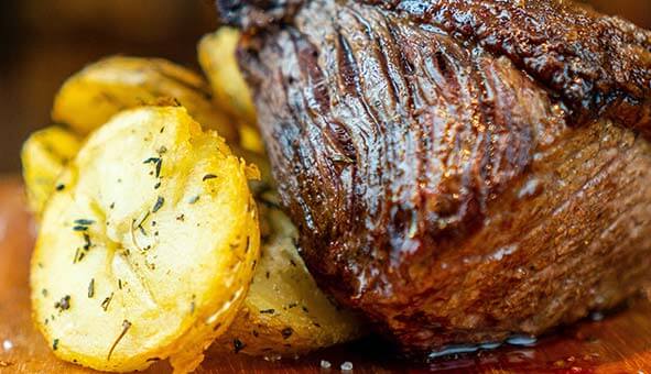 a succulent cut of beef with crispy roasted potatoes
